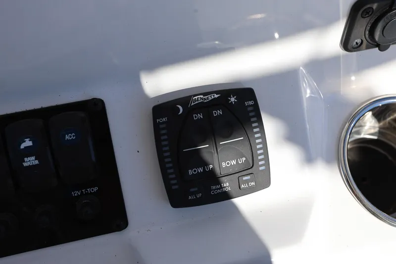 Slide: The Image of Control panel of 2025 Stingray 216 CC boat with trim tab switches. - 12