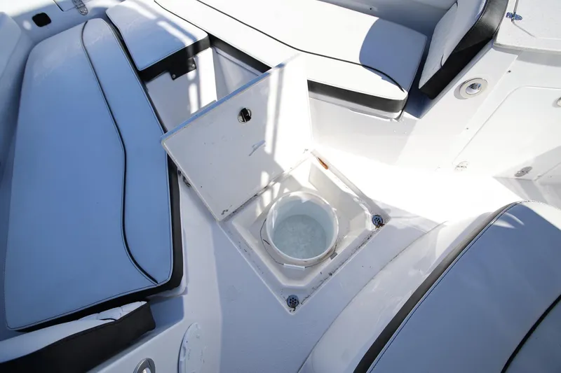 Slide: The Image of 2025 Stingray 216 CC boat interior with open storage compartment and seating. - 17