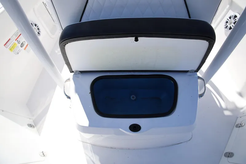 Slide: The Image of 2025 Stingray 216 CC boat interior with open storage compartment. - 18