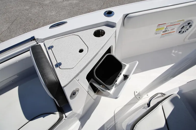Slide: The Image of 2025 Stingray 216 CC boat interior with storage compartment and seating. - 19
