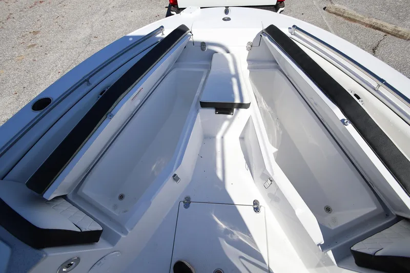 Slide: The Image of 2025 Stingray 216 CC boat interior with open storage compartments. - 21