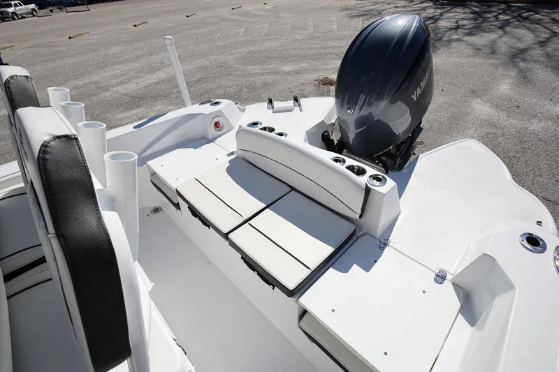 Slide: The Image of 2025 Stingray 216 CC boat interior with Yamaha engine, featuring seating and rod holders. - 6