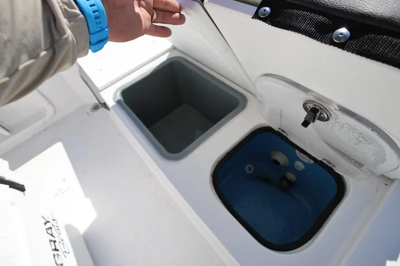 Slide: The Image of 2025 Stingray 216 CC boat storage compartments with open lids, showcasing interior design. - 9