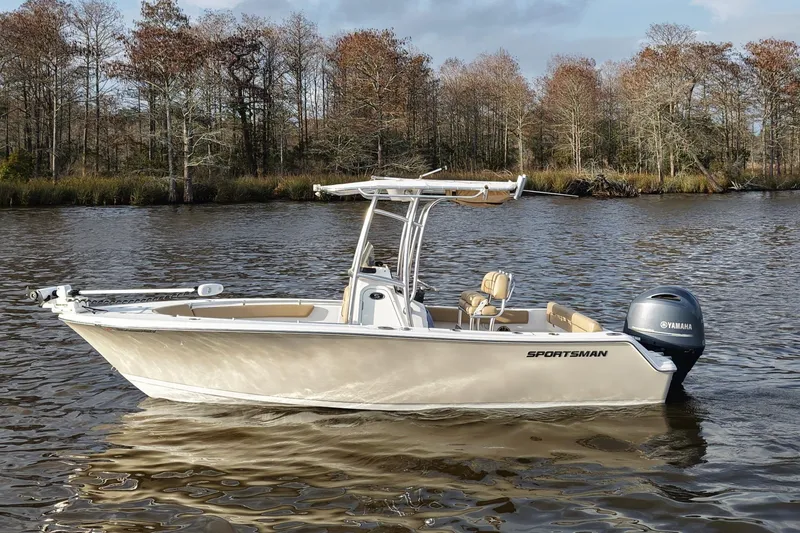 Slide: The Image of 2017 Sportsman Heritage 211 Center Console boat on a calm lake with autumn trees. - 0