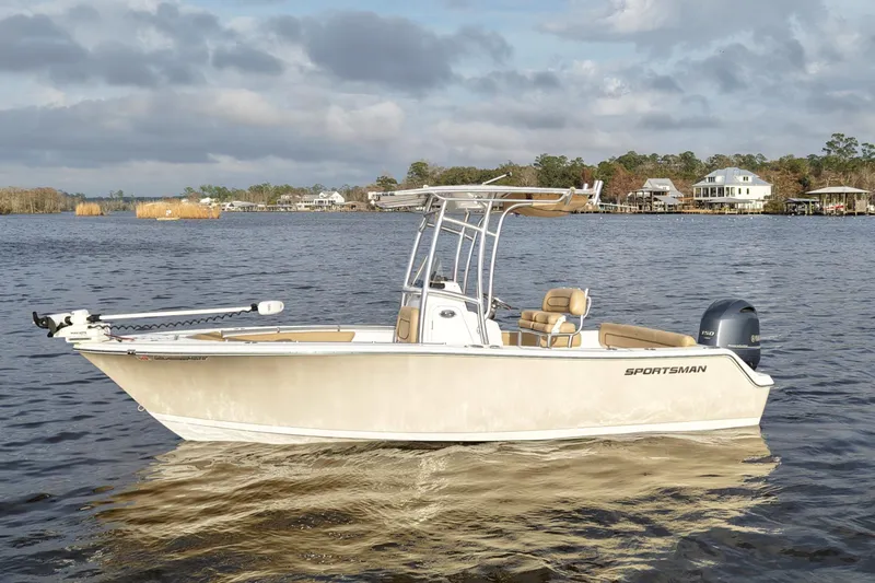 Slide: The Image of 2017 Sportsman Heritage 211 Center Console boat on a calm lake. - 1