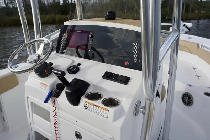Slide: The Image of 2017 Sportsman Heritage 211 Center Console boat dashboard with steering wheel and controls. - 11