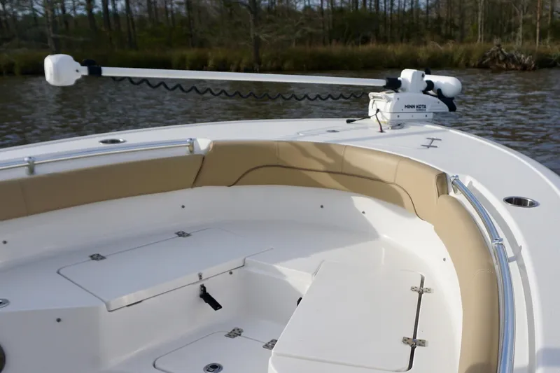 Slide: The Image of 2017 Sportsman Heritage 211 Center Console boat interior with seating and trolling motor. - 6