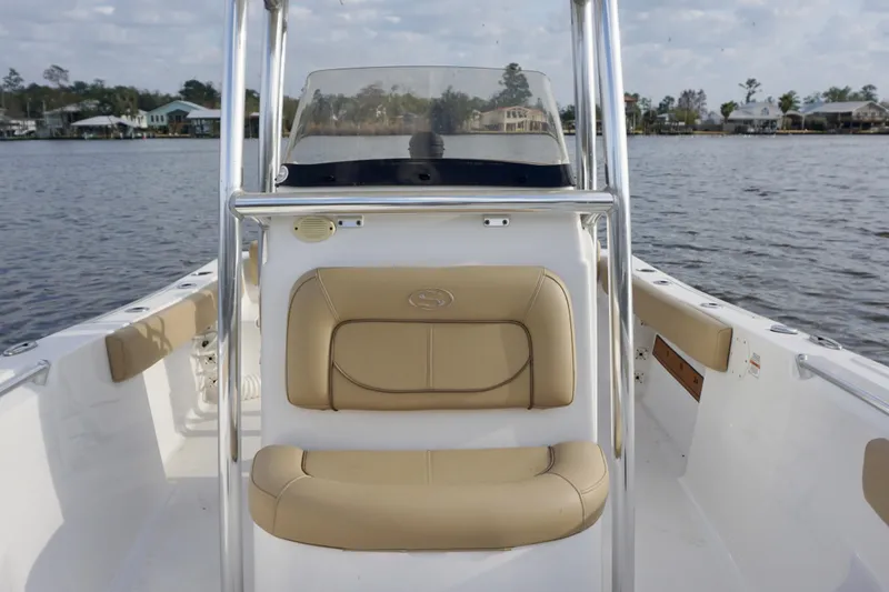 Slide: The Image of 2017 Sportsman Heritage 211 Center Console boat on calm water, featuring tan seating. - 7