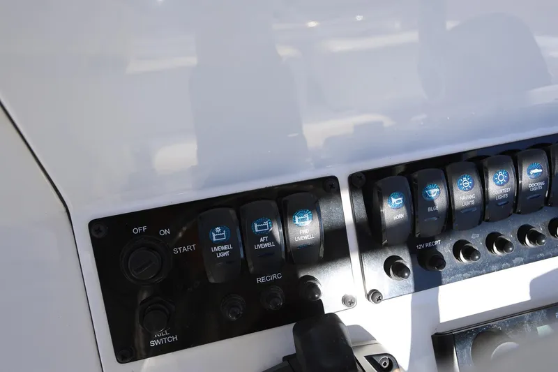 Slide: The Image of Control panel of 2025 Stingray 216 CC boat with various switches and buttons. - 12