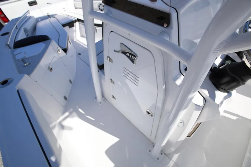 Slide: The Image of 2025 Stingray 216 CC boat interior, featuring sleek white design and modern console. - 16