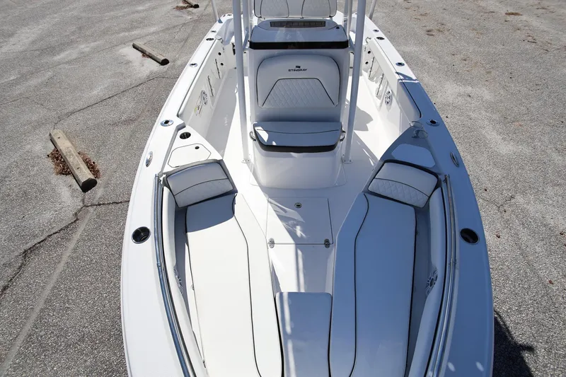 Slide: The Image of 2025 Stingray 216 CC boat interior with white seating and sleek design. - 21