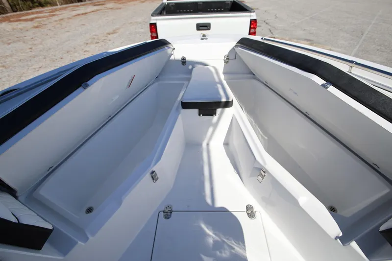 Slide: The Image of 2025 Stingray 216 CC boat interior with open storage compartments, viewed from above. - 22