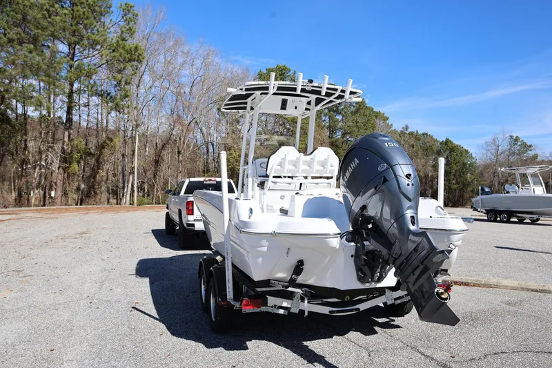 Slide: The Image of 2025 Stingray 216 CC boat with Yamaha engine on trailer, parked outdoors. - 3