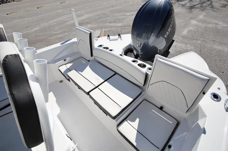 Slide: The Image of 2025 Stingray 216 CC boat interior with Yamaha engine, featuring white cushioned seating and cup holders. - 7
