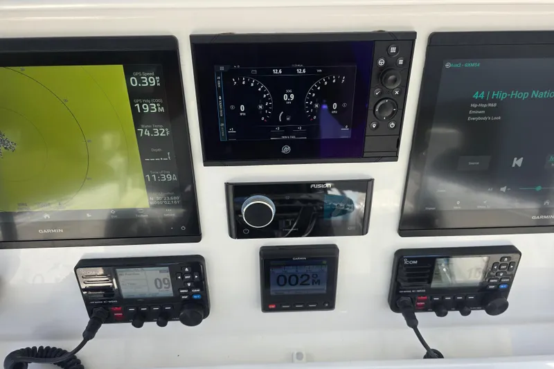 Slide: The Image of Control panel of 2022 Invincible 33 Catamaran with various electronic switches and indicators. - 23