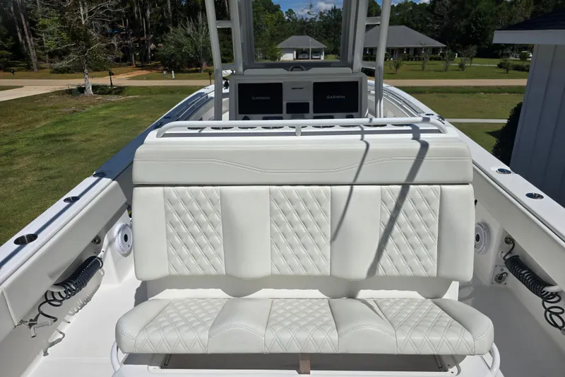 Slide: The Image of 2022 Invincible 33 Catamaran interior with cushioned seating and cup holders. - 28