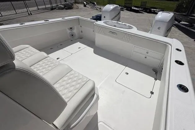 Slide: The Image of 2022 Invincible 33 Catamaran with Garmin system, sleek white deck, and comfortable seating. - 31
