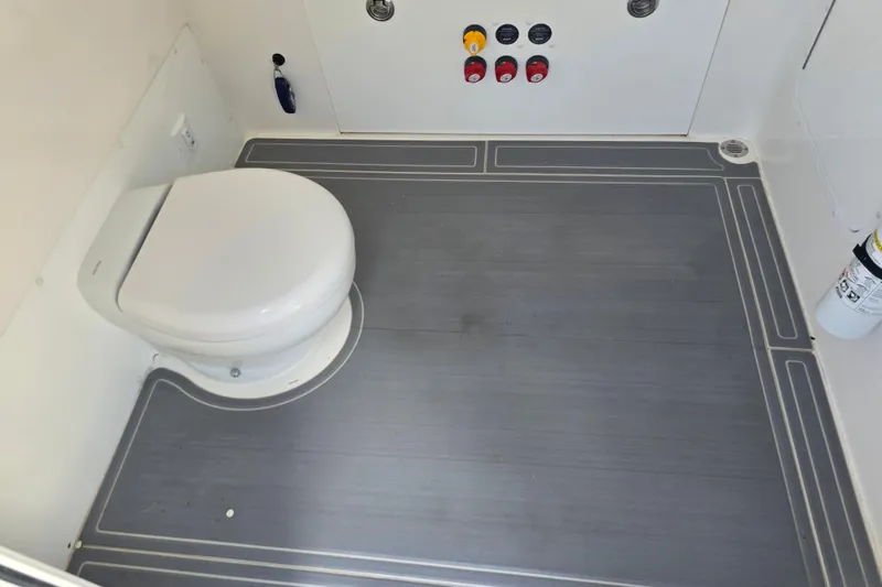 Slide: The Image of 2022 Invincible 33 Catamaran boat interior with white seating and storage compartment. - 34