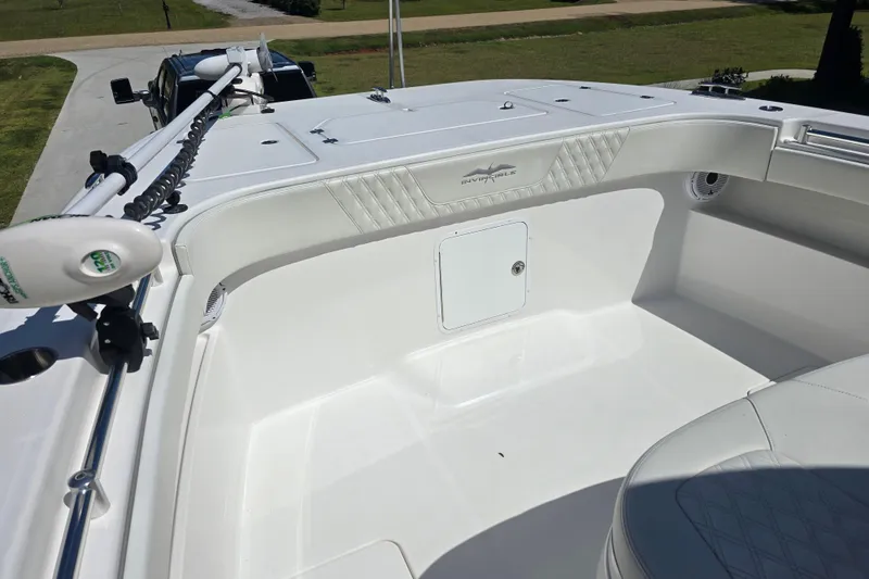 Slide: The Image of Open storage compartment on 2022 Invincible 33 Catamaran with white cushioned seating. - 38