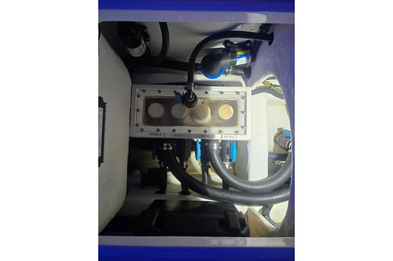 Slide: The Image of 2022 Invincible 33 Catamaran interior with blue LED lighting and cushioned seating. - 56