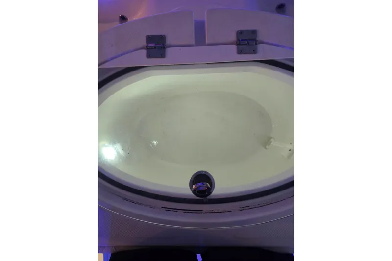 Slide: The Image of 2022 Invincible 33 Catamaran interior with blue LED lighting and cushioned seating. - 58