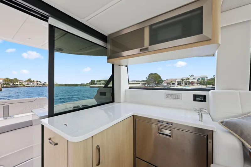 Slide: The Image of Luxurious interior of 2024 Regal 38 XO yacht with modern kitchen and waterfront view. - 11