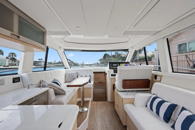 Slide: The Image of Luxurious interior of 2024 Regal 38 XO yacht with modern seating and panoramic windows. - 13