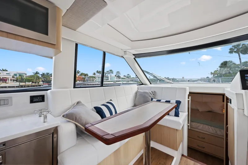 Slide: The Image of Luxurious interior of 2024 Regal 38 XO yacht with plush seating and scenic windows. - 14