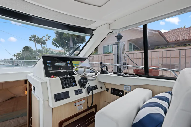Slide: The Image of 2024 Regal 38 XO yacht interior with modern helm and navigation controls. - 19