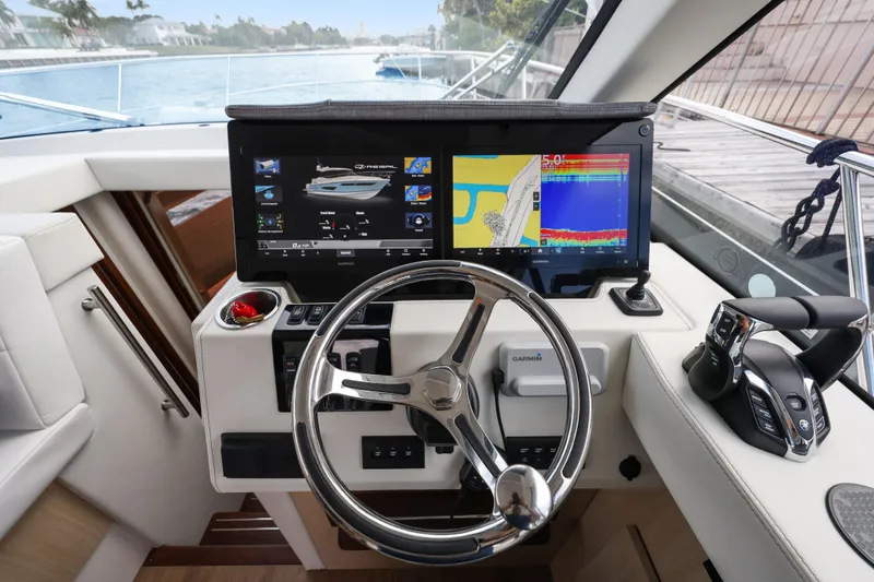 Slide: The Image of 2024 Regal 38 XO helm with advanced navigation displays and controls. - 21