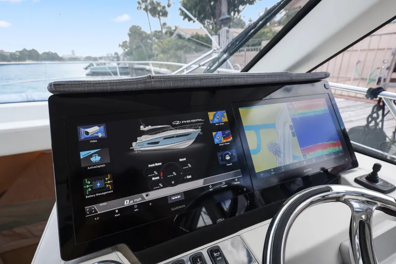 Slide: The Image of 2024 Regal 38 XO yacht dashboard with advanced navigation and control displays. - 23