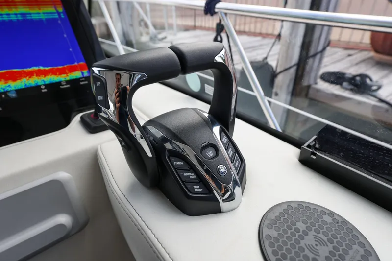 Slide: The Image of 2024 Regal 38 XO boat throttle control with digital display and sleek design. - 24