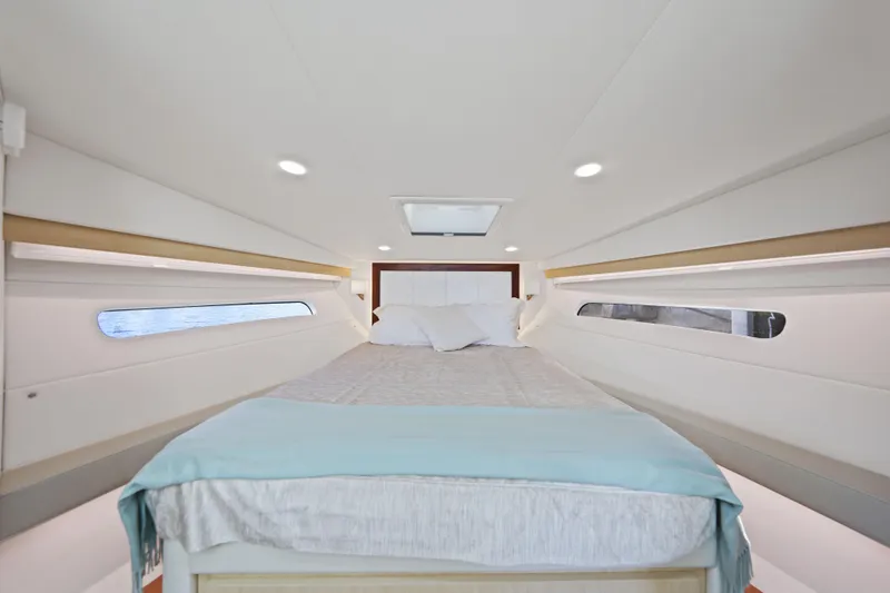 Slide: The Image of Luxurious interior cabin of 2024 Regal 38 XO yacht with comfortable bedding. - 25