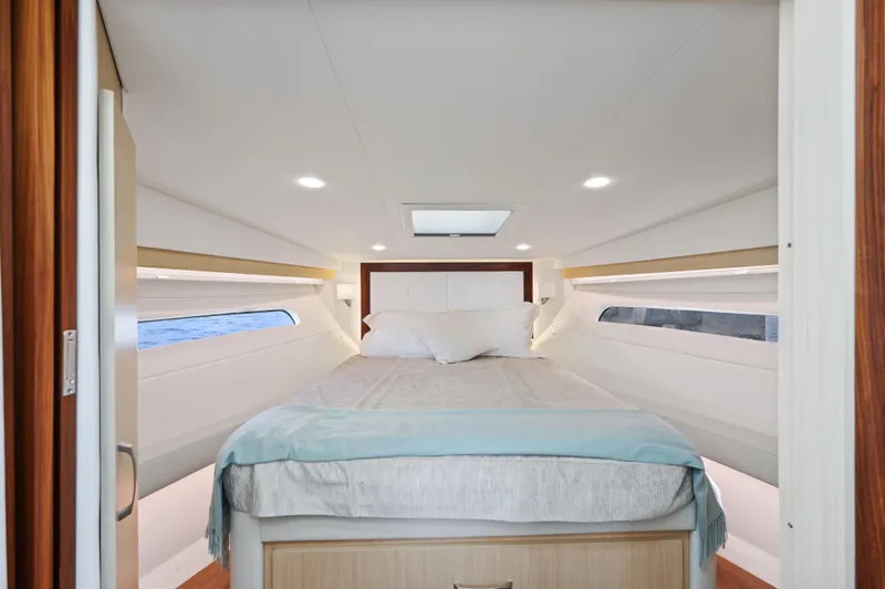 Slide: The Image of Luxurious cabin interior of 2024 Regal 38 XO yacht with cozy bed and modern design. - 26