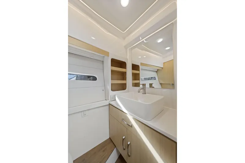 Slide: The Image of Luxurious bathroom interior of 2024 Regal 38 XO yacht with modern sink and mirror. - 28