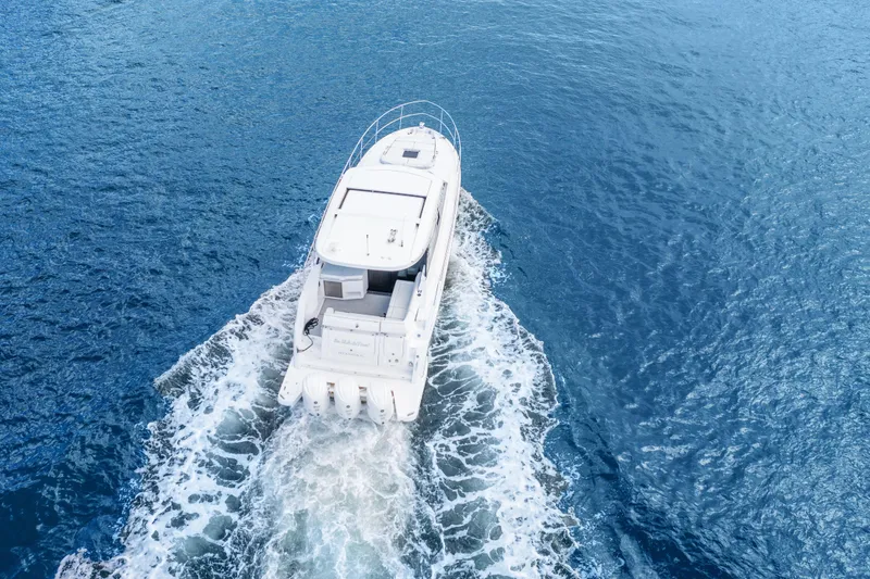 Slide: The Image of 2024 Regal 38 XO yacht cruising on open blue water. - 5