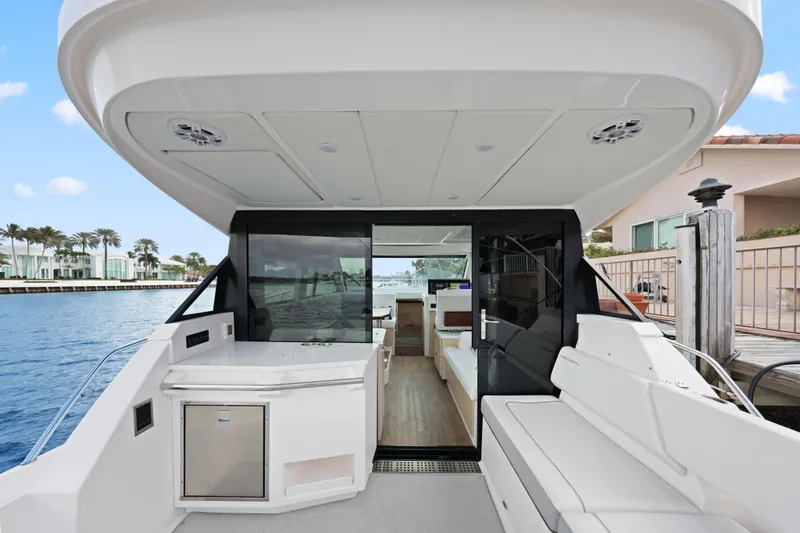Slide: The Image of 2024 Regal 38 XO yacht interior with sleek design and waterfront view. - 8