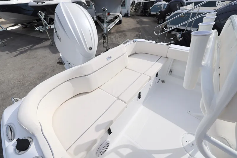 Slide: The Image of 2026 Sea Hunt Ultra 219 boat interior with cushioned seating and Yamaha outboard motor. - 10