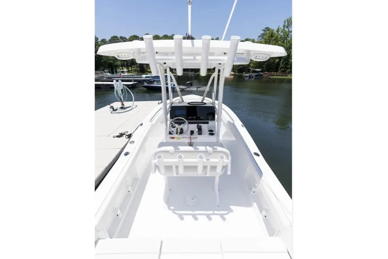 Slide: The Image of Manufacturer Provided Image: 2026 Sea Hunt Ultra 219 boat interior with console, docked on a sunny day. - 19