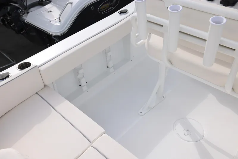 Slide: The Image of 2026 Sea Hunt Ultra 219 boat interior with rod holders and seating area. - 8