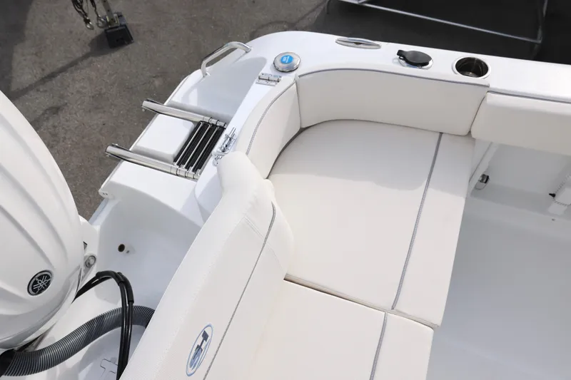 Slide: The Image of 2026 Sea Hunt Ultra 219 boat interior with white seating and swim ladder. - 9