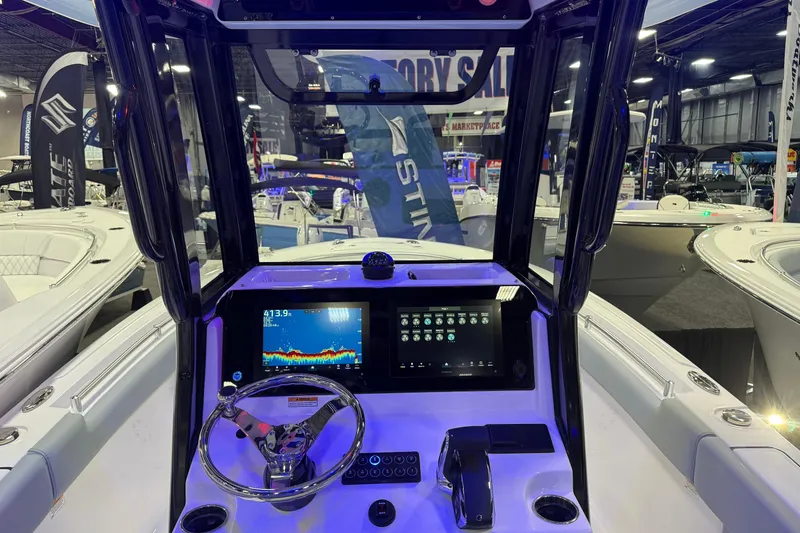 Slide: The Image of 2026 Sportsman Heritage 231 Center Console boat interior with advanced navigation display. - 1