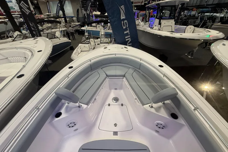 Slide: The Image of 2026 Sportsman Heritage 231 Center Console boat interior at a showroom display. - 11