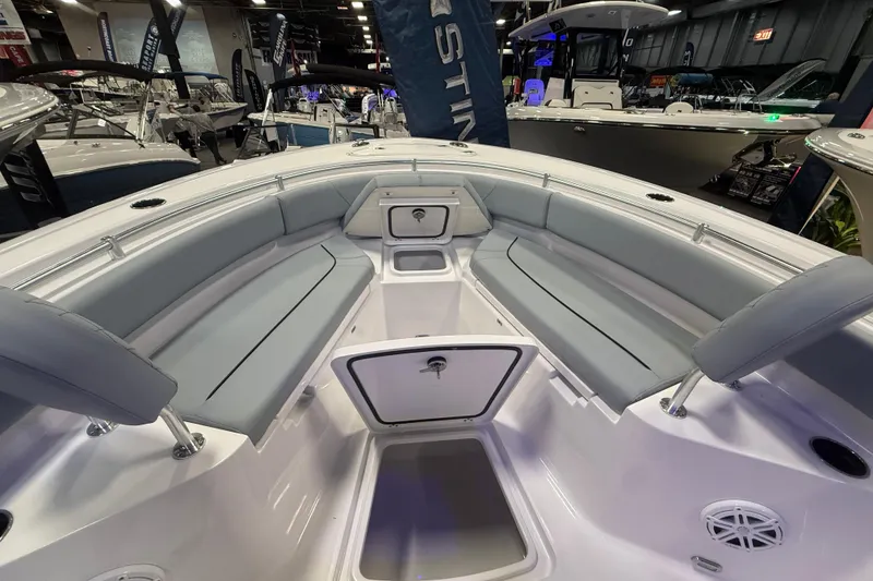 Slide: The Image of 2026 Sportsman Heritage 231 Center Console boat interior with gray seating and storage compartments. - 12
