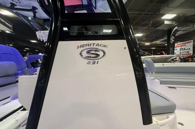 Slide: The Image of 2026 Sportsman Heritage 231 Center Console boat interior at a showroom display. - 2