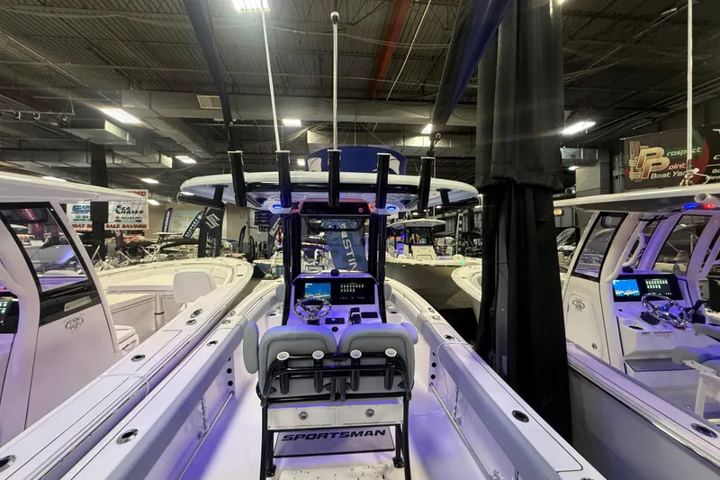 Slide: The Image of 2026 Sportsman Heritage 231 Center Console boat displayed at an indoor showroom. - 4
