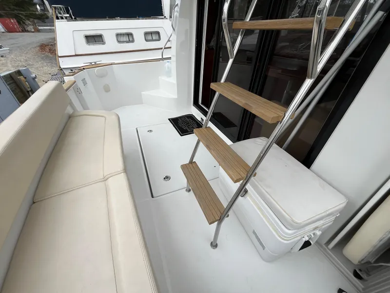 Slide: The Image of 2013 Beneteau Swift Trawler 34 deck with seating and ladder. - 12
