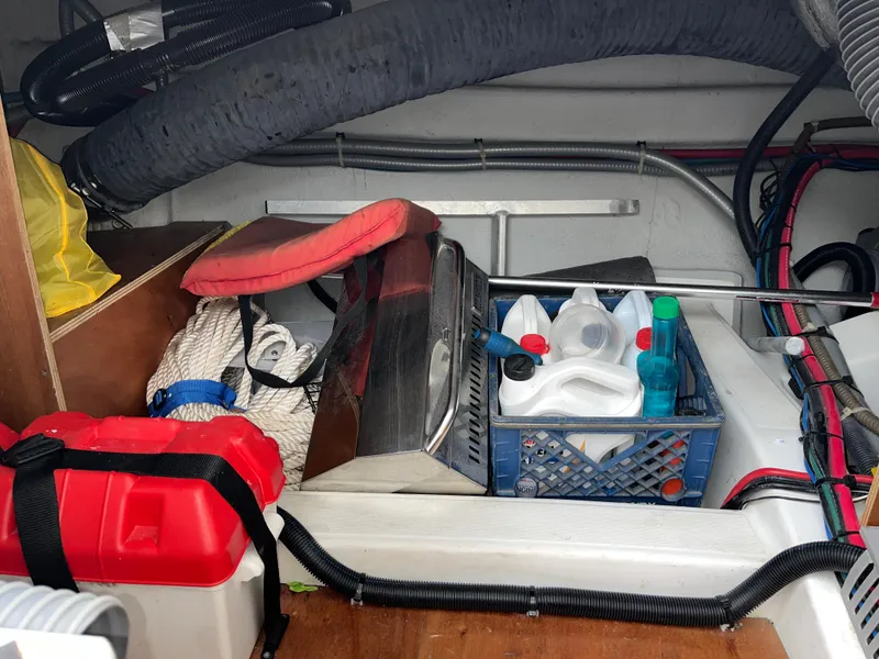 Slide: The Image of Storage compartment of 2013 Beneteau Swift Trawler 34 with ropes and cleaning supplies. - 20