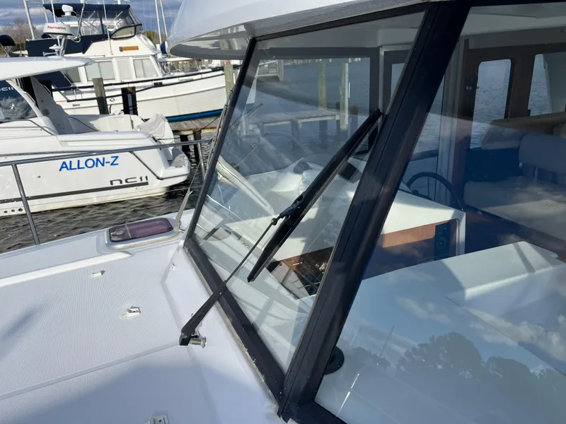 Slide: The Image of 2013 Beneteau Swift Trawler 34 docked, showcasing windshield and deck details. - 26