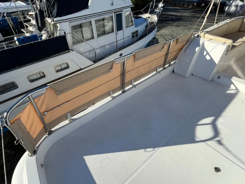 Slide: The Image of 2013 Beneteau Swift Trawler 34 deck with railing and adjacent boat view. - 45